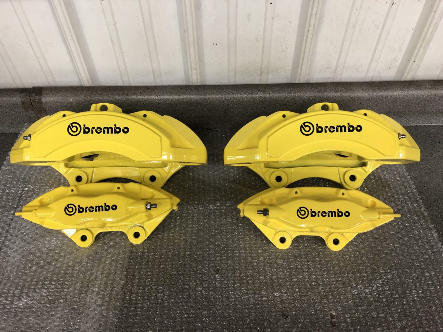 Two yellow Custom fabricated auto parts