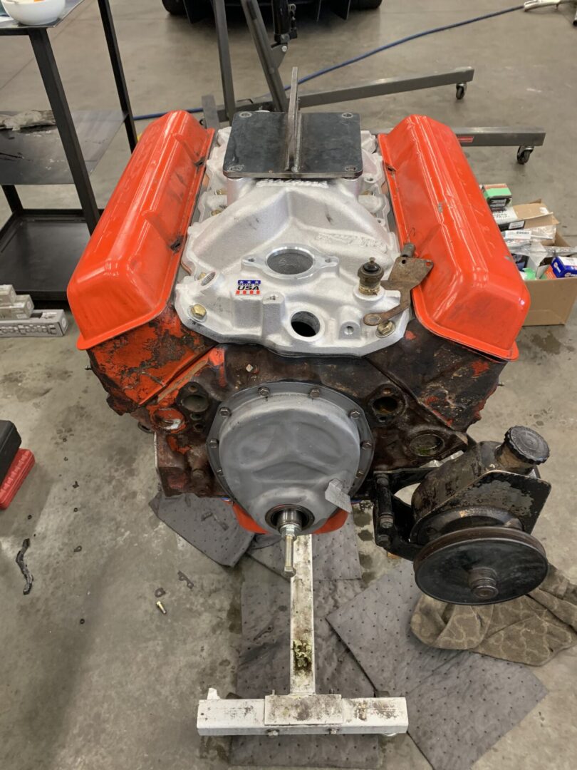 A heavy, fabricated auto part, orange