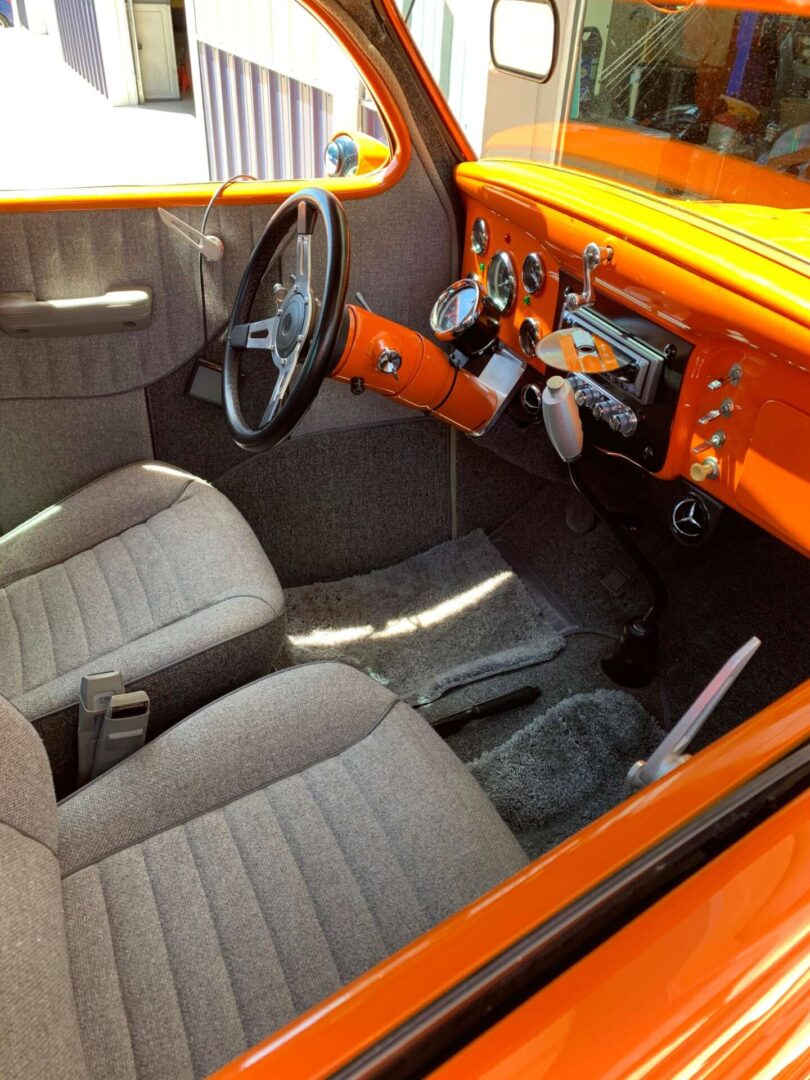 An orange steering wheel of an orange car