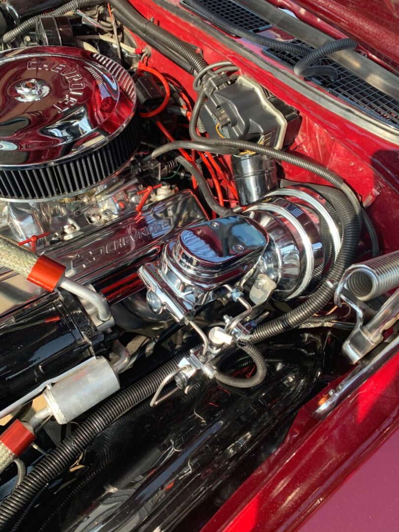 A red car engine under the sunlight
