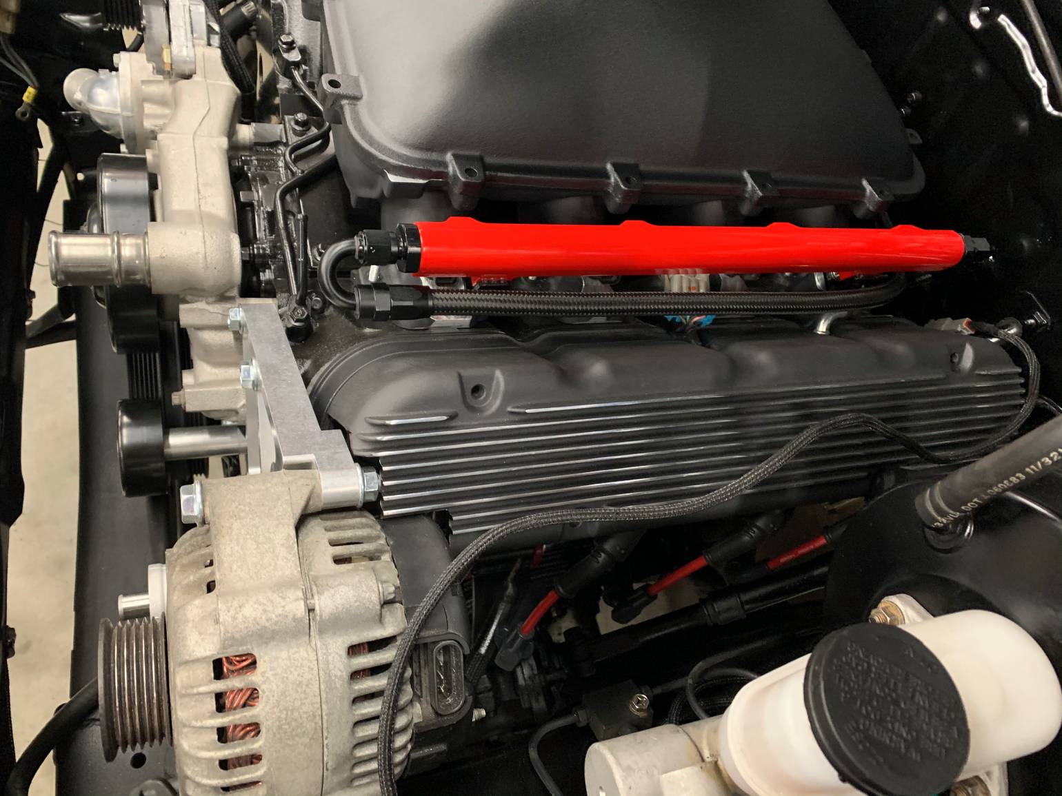 A brand new car part with a red tube