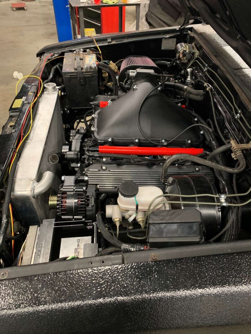 The inside of an engine of a black car