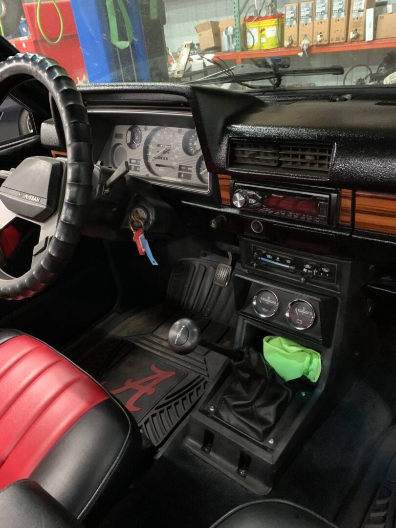 The interior of a red vintage car with red seats