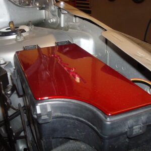 A red coated caliber fuse box cover