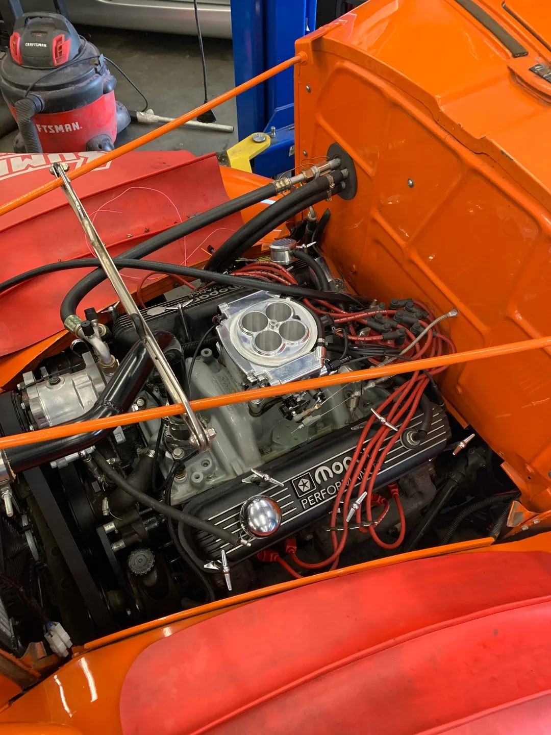 An inside view of an orange engine and battery