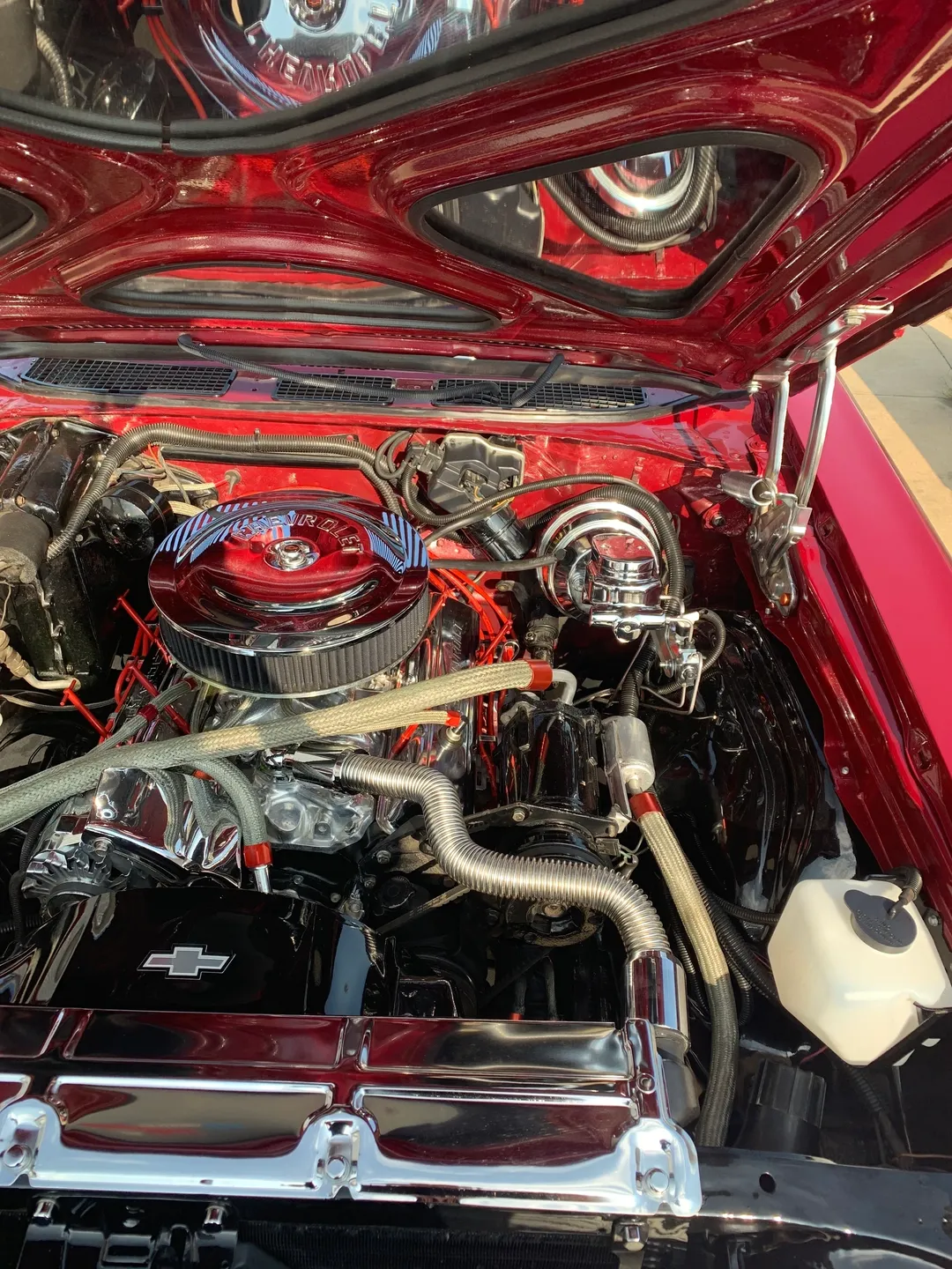 The inside of a hood of the red vintage car