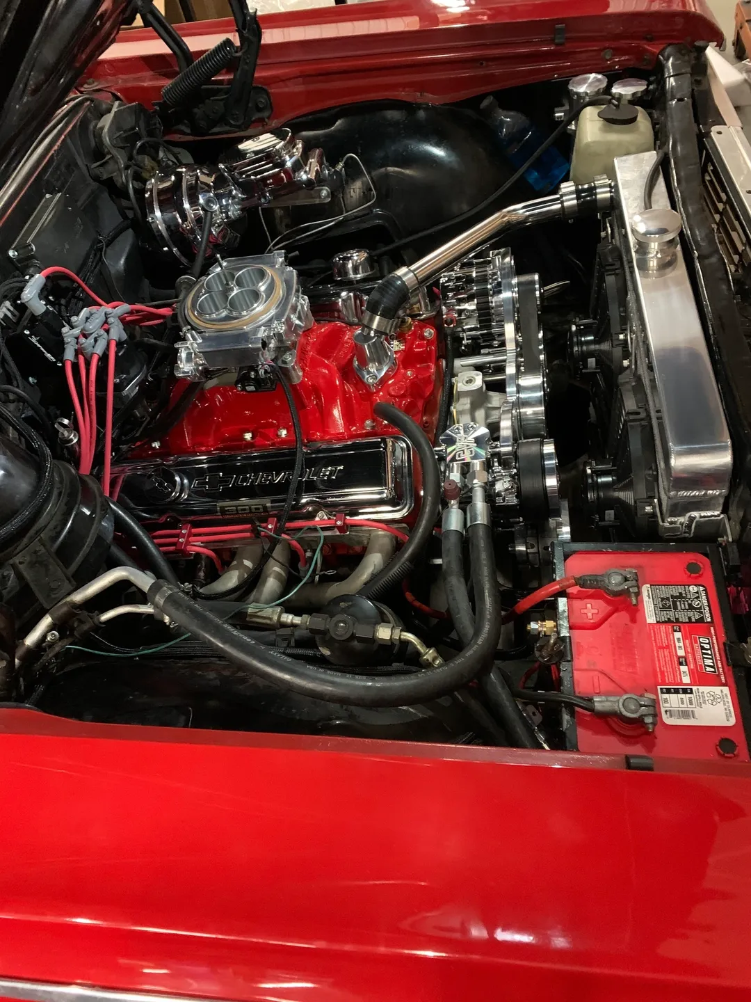 A red hood engine of a red vintage car